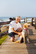 active senior man and his dog at the beach