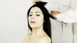 Woman getting hairdo by hair stylist
