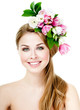 Photo: Smiling beautiful woman with flowers in her hair Smiling beautiful woman with flowers in her hair