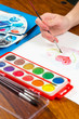 Young girl hands with paintbrush