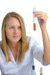 Young beautiful female scientist with flasks