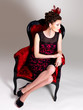 Photo: Woman with fashion hairstyle and red armchair Woman with fashion hairstyle and red armchair