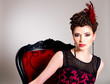 Photo: Woman with fashion hairstyle and red armchair Woman with fashion hairstyle and red armchair
