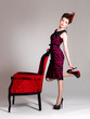 Photo: Woman with fashion hairstyle and red armchair Woman with fashion hairstyle and red armchair