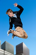 Energetic boy jumping in city.