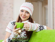 woman warms with cup of tea