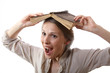 girl with a book on her head, isolated on white