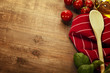 Wooden spoon and ingredients on table