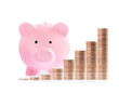 Pink piggy bank and Stacks of money coins
