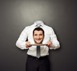 headless man holding smiley head