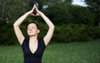 Young woman doing yoga exercises outdoors