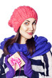 Happy woman in winter clothing holding Christmas present box