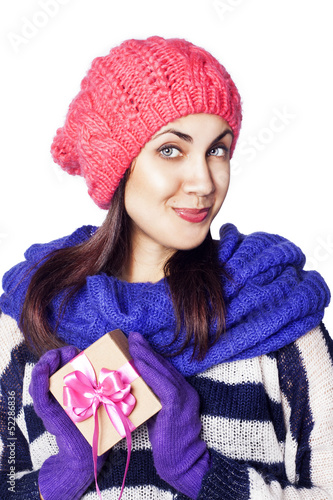 Photo: Happy woman in winter clothing holding Christmas present box Happy woman in winter clothing holding Christmas present box
