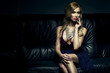 Beautiful luxurious woman sitting on a couch