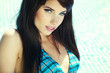 Pretty woman in white bikini floating in swimming pool
