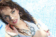 Beautiful young sexy woman by a swimming pool