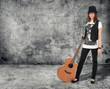 Photo: girl with the guitar. gray concrete wall girl with the guitar. gray concrete wall