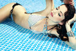 Sexy girl relaxing in a pool