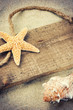 Old wooden board with seashells