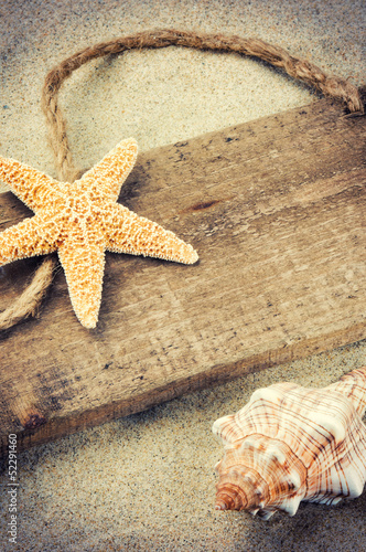 Photo: Old wooden board with seashells Old wooden board with seashells