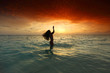 Woman splashing in sea on sunset