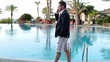 Young businessman talking on cellphone in luxury resort