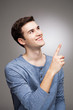 Photo: Young man pointing up Young man pointing up