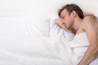 Upset man lies in the bed
