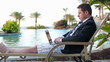Video: Businessman with laptop on sunbed by the pool Businessman with laptop on sunbed by the pool