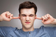 Man putting fingers in ears