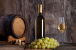 White wine, grapes, old bottle and a barrel.