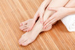 Photo: Beautiful female hands and feet with white towel Beautiful female hands and feet with white towel