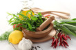 fresh herbs with mortar and pestle