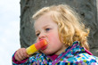 Foto: child is eating iced-lolly child is eating iced-lolly