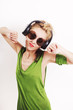 Foto: Dancing young woman wearing headphones and sunglasses Dancing young woman wearing headphones and sunglasses