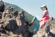 Woman sitting on rock in mountains