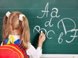 Schoolchild writting on blackboard
