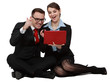 Happy Young Couple on Laptops