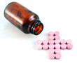 Cross shape pills and a bottle on white background