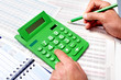 Hand of businessman with calculator.