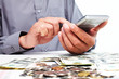 Hand with calculator and money.