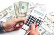 Hand with calculator and money.