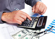 Hand with calculator and money.