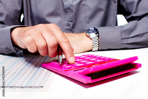 Photo: Hand of a businessman with calculator. Hand of a businessman with calculator.