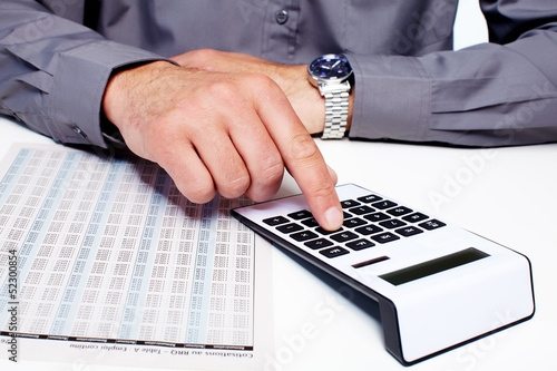 Photo: Hand of a businessman with calculator. Hand of a businessman with calculator.