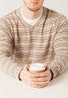 man hand holding take away coffee cup