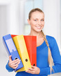young attractive businesswoman with folders