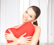woman with red heart-shaped pillow