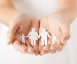 womans hands with paper man family womans hands with paper man family
