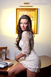 Sensual elegant young woman in white dress holding  a wine glass